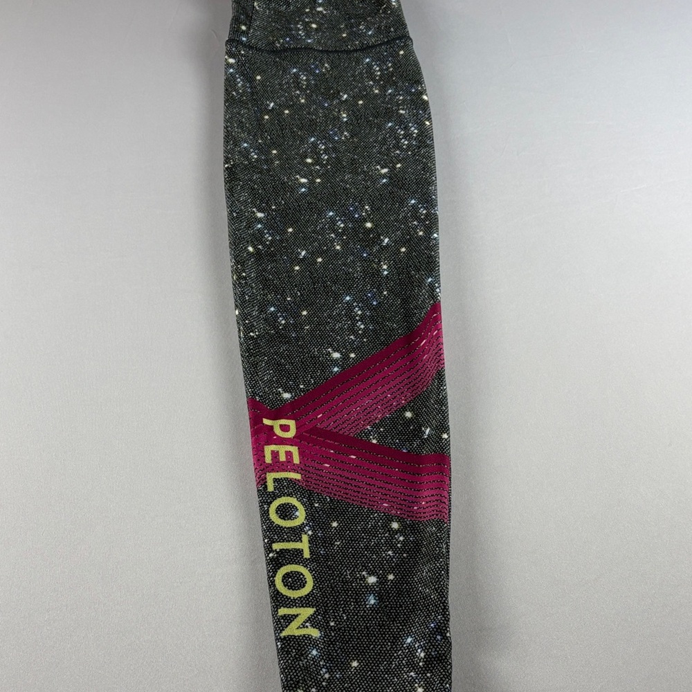 Peloton Black Sparkle like pattern leggings with Pink diagonal accent